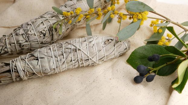 Dried white sage smudge stick, relaxation and aromatherapy. Smudging during psychic occult ceremony, herbal healing, yoga or aura cleaning. Essential incense for esoteric rituals and fortune telling.