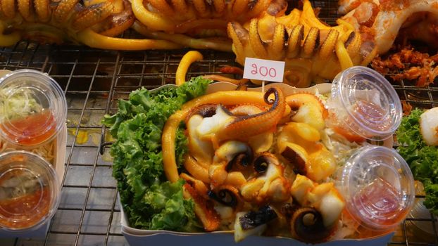 National Asian Exotic ready to eat seafood at night street market food court in Thailand. Delicious Grilled Prawns or Shrimps and other snacks
