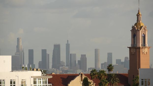 Highrise skyscrapers of metropolis in smog, Los Angeles, California USA. Air toxic pollution and misty urban downtown skyline. Cityscape in dirty fog. Low visibility in city with ecology problems.