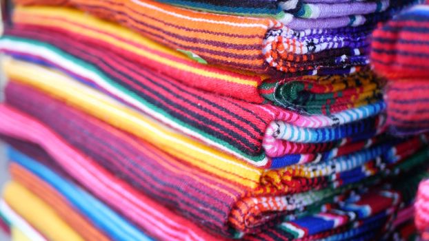 Colorful mexican wool serape blankets texture. Woven ornamental vivid textile with authentic latin american pattern. Striped multi colored fabric for poncho and sombrero. Hispanic indigenous style.