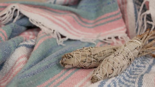 Dried white sage smudge stick, relaxation and aromatherapy. Smudging during psychic occult ceremony, herbal healing, yoga or aura cleaning. Essential incense for esoteric rituals and fortune telling.