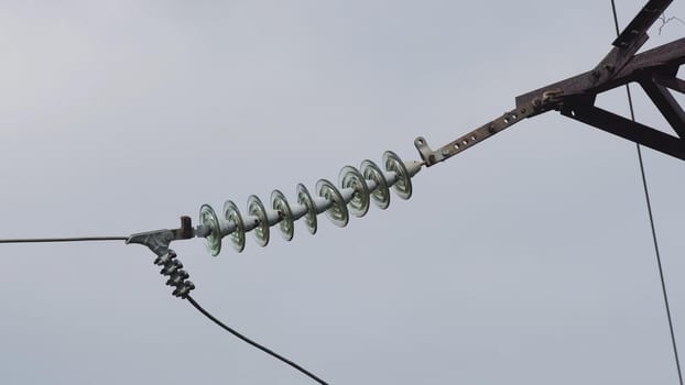 High voltage post.High-voltage tower sky background. High-voltage electrical insulator electric line against the blue sky. Electricity transmission power lines.