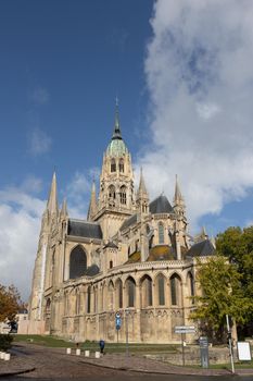 Bayeux Normandy France 10.18.2019 cathedral exterior of Romanesque architecture rising up from a low angle to blue sky. High quality photo