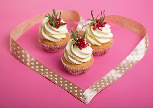 Valentines cupcakes with vanilla icing and decorated with ribbon heart.