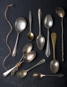 Flat lay. Placed on a black background empty wooden spoon, five pieces Placed on a black background