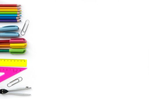 School and Office drawing supplies isolated on white background. Free space for text. Back to school. Top view border of colour pencils, rulers and note