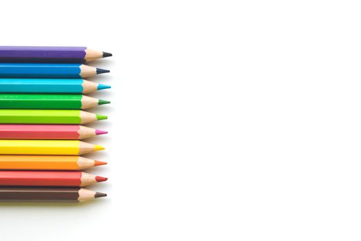 Color pencils on white paper background, copy space. Office supplies, back to school. Top view. Banner