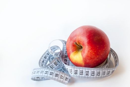 Apple and measuring tape on white background. Diet concept