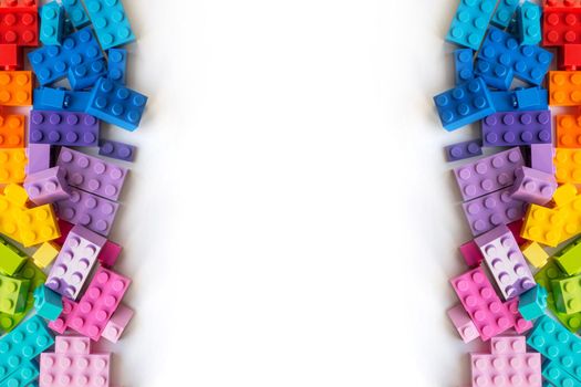 A bunch of Multicolor Plastick constructor bricks on white background. Popular toys. Copyspace