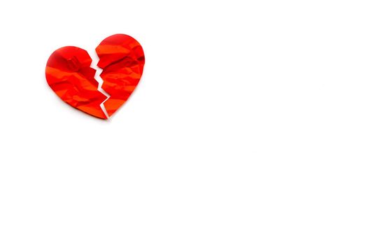 Red paper broken heart on white background. Love concept. Divorce. Copyspace
