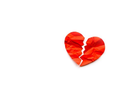 Red paper broken heart on white background. Love concept. Divorce. Copyspace