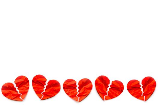 Border of many Red paper broken hearts on white background. Love concept. Divorce. Copyspace