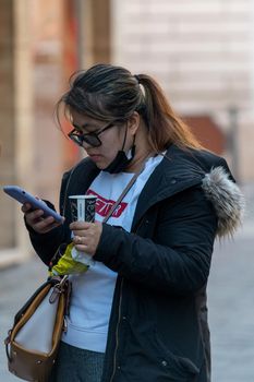 terni,italy february 05 2021:Chinese woman looking at a smartphone