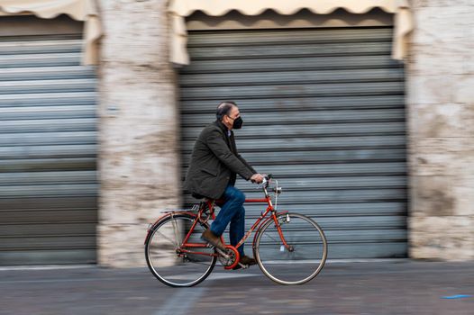 terni,italy february 05 2021:man on a bicycle in the central square of terni