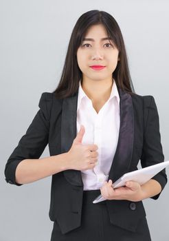 Young Asain women long hair in suit standing using her digital tablet computer