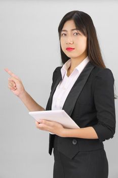 Young Asain women long hair in suit standing using her digital tablet computer  and pointing finger