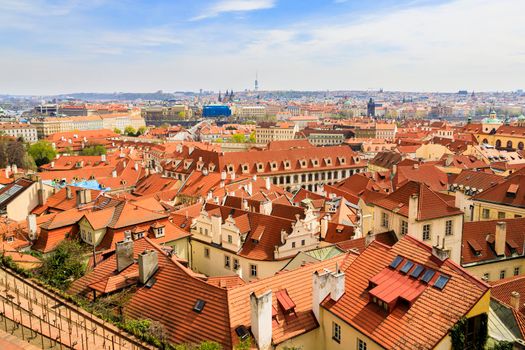 Red-brown roofs of beautiful cities made of natural tiles. The view from the top. in the distance, the horizon of the blue sky.