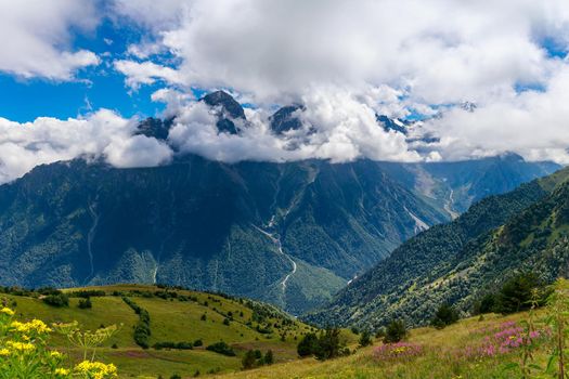 The Caucasus mountains, a glacier on top of the rocks, from the glacier there are three waterfalls. A great fascinating landscape.