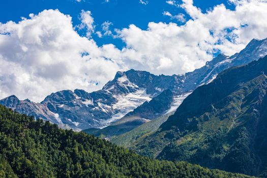 The Caucasus mountains, a glacier on top of the rocks, from the glacier there are three waterfalls. A great fascinating landscape.