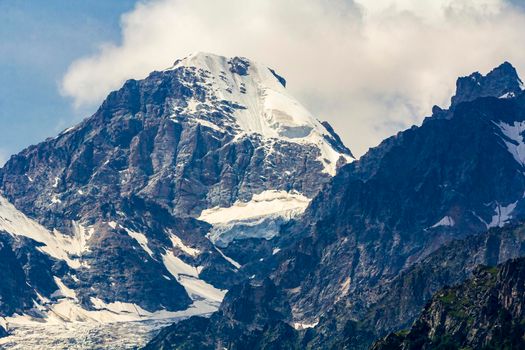 The Caucasus mountains, a glacier on top of the rocks, from the glacier there are three waterfalls. A great fascinating landscape.