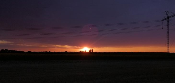 sunset on the background of power lines. High quality photo