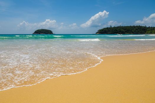 Beautiful sea Sunny landscape on the beach. Light waves of blue color spread all over the beach smoothly smoothing the Golden sand.