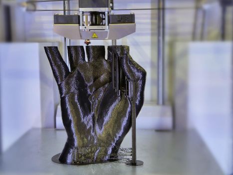 3D printer head operating to generate a black human hand selective focus
