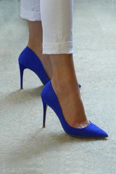 Woman wearing blue high heels shoes close up view
