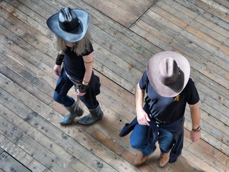 Couple of traditional western folk music dancers view from above