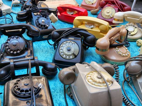 Vintage rotary dial telephones on display in flea market