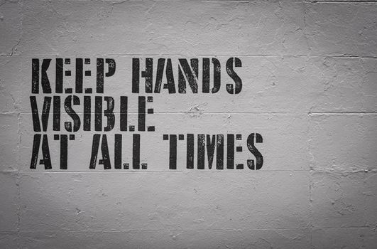 A Keep Hands Visible At All Times Sign On The Wall Of A Visitors Area Of A Prison Or Jail