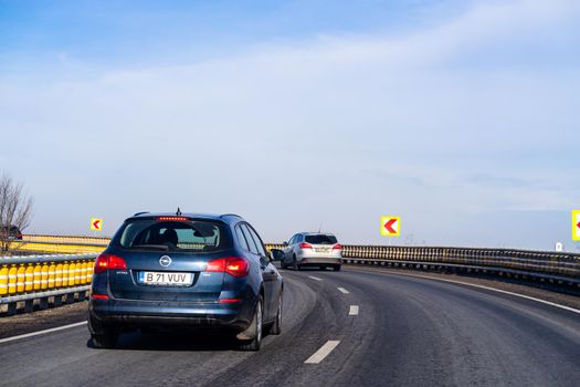 Road view through car windshield, cars on road in traffic in Bucharest, Romania, 2021