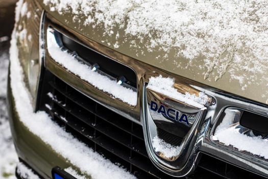 Car logo DACIA covered with snow close up. Snow on Dacia Duster in Bucharest, Romania, 2021