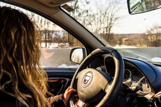 Driving Dacia, close up of dashboard, steering wheel with air bag sign. View of car interior in Bucharest, Romania, 2021