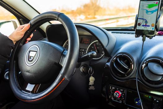 Driving Dacia, close up of dashboard, steering wheel with air bag sign. View of car interior in Bucharest, Romania, 2021