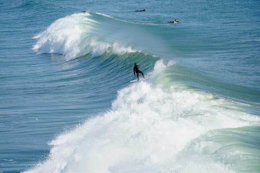 Male surfers enjoying the big wave in Oceanside in North San Diego, California, USA. Travel destination in the South West Coast famous for surfer. January 2n, 2021