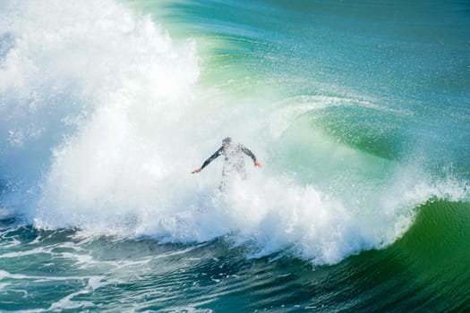 Male surfers enjoying the big wave in Oceanside in North San Diego, California, USA. Travel destination in the South West Coast famous for surfer. January 2n, 2021