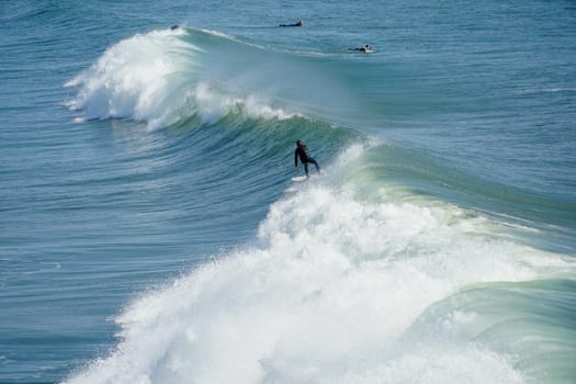 Male surfers enjoying the big wave in Oceanside in North San Diego, California, USA. Travel destination in the South West Coast famous for surfer. January 2n, 2021