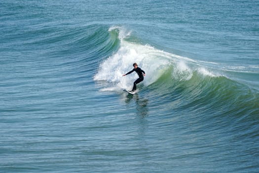 Male surfers enjoying the big wave in Oceanside in North San Diego, California, USA. Travel destination in the South West Coast famous for surfer. January 2n, 2021