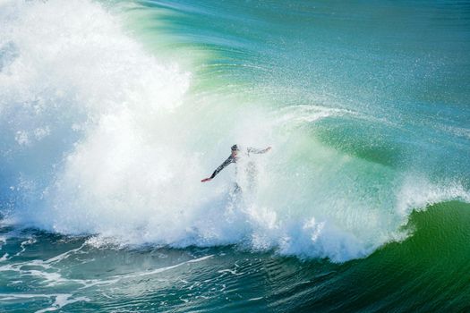 Male surfers enjoying the big wave in Oceanside in North San Diego, California, USA. Travel destination in the South West Coast famous for surfer. January 2n, 2021