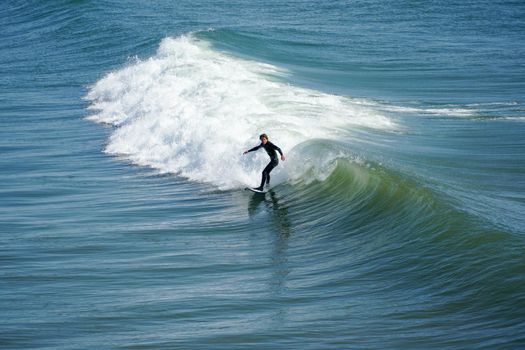 Male surfers enjoying the big wave in Oceanside in North San Diego, California, USA. Travel destination in the South West Coast famous for surfer. January 2n, 2021