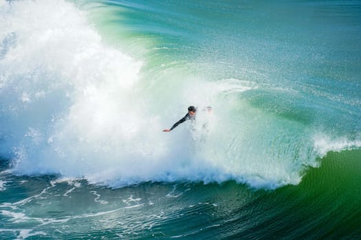 Male surfers enjoying the big wave in Oceanside in North San Diego, California, USA. Travel destination in the South West Coast famous for surfer. January 2n, 2021