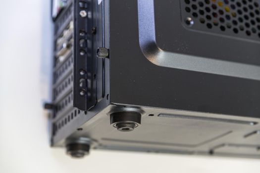 rubber legs or stands on generic black computer case for vibration and noise reduction - close-up with selective focus