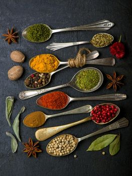 Various spices spoons on table. Top view with copy space