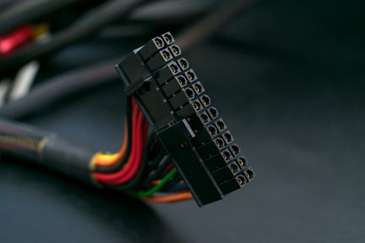 Black power connector of computer motherboard on dark background