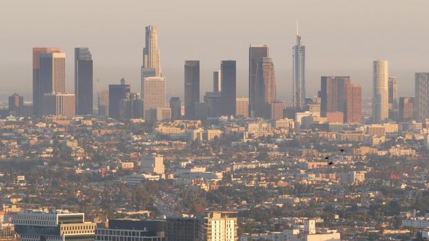 Highrise skyscrapers of metropolis in smog, Los Angeles, California USA. Air toxic pollution and misty urban downtown skyline. Cityscape in dirty fog. Low visibility in city with ecology problems.
