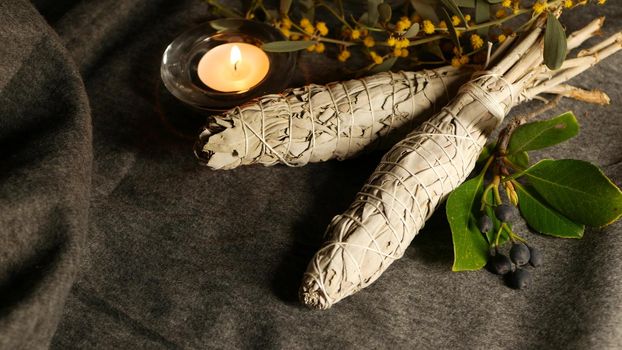 Dried white sage smudge stick, relaxation and aromatherapy. Smudging during psychic occult ceremony, herbal healing, yoga or aura cleaning. Essential incense for esoteric rituals and fortune telling.