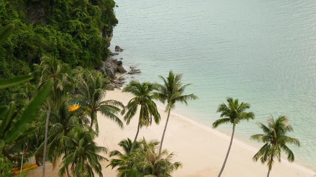 Calm sea near green jungle. Peaceful ocean with turquoise water, white sandy tropical shore in Ang Thong paradise national park, Thailand. Rainforest and rocks. Dream beach, relax and holiday concept.