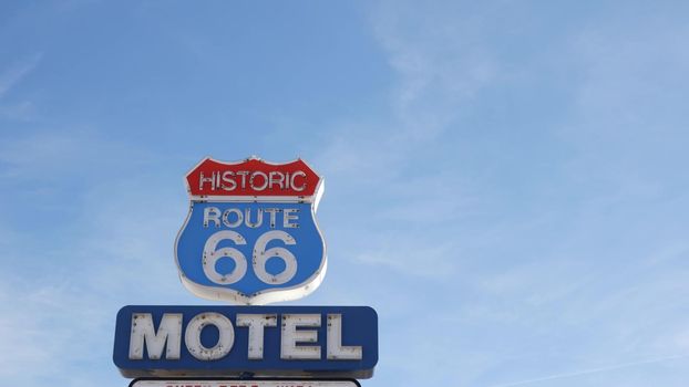 Motel retro sign on historic route 66 famous travel destination, vintage symbol of road trip in USA. Iconic lodging signboard in Arizona desert. Old-fashioned neon signage. Classic tourist landmark.