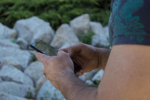 man doing sports, with his cell phone in the park in the afternoon